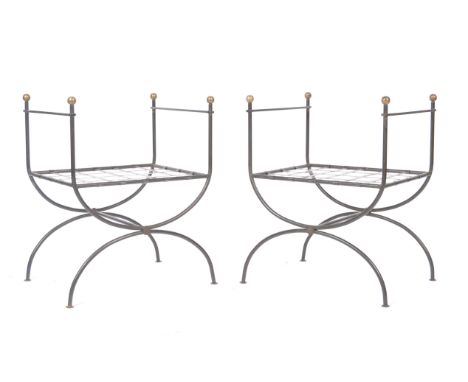 A pair of vintage 20th Century polished iron and brass Curule 'X' frame throne chairs of open form. Each chair having square 