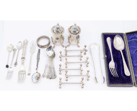 A collection of silver to include; A pair of Exeter silver sugar tongs, two silver and enamel spoons , one with Egyptian scen