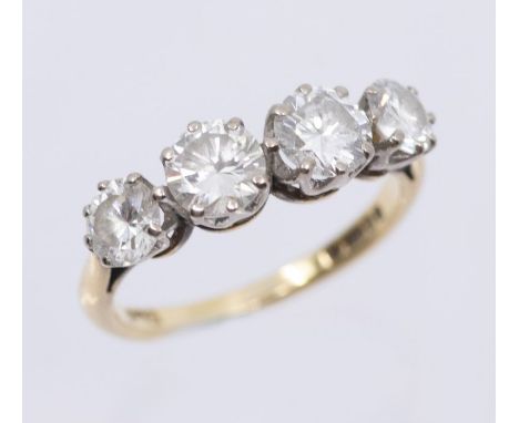 An diamond and 18ct gold four stone ring, comprising four claw set round brilliant cut diamonds tapering in size, total diamo