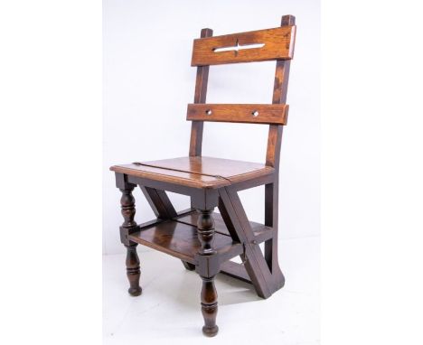 A Victorian oak Gothic design metamorphic library chair / step, with pierced bar back, folding out to create a set of library