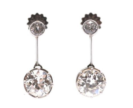 A pair of early 20th century diamond and platinum drop earrings, each comprising a single rub over set, milled border old cut