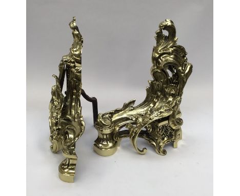 A pair of Neo-Classical cast gilt brass andirons.With ornate scroll and leaf decoration.Approximately 39cm H x 34cm D x 17.5c