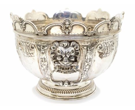 A Queen Anne style silver monteith / punch bowl, circular form with semi elliptical wavy edge cut border each section surmoun