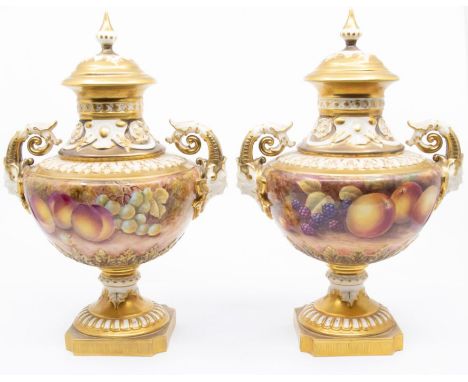 A pair of Royal Worcester two handled vase and covers, shape no: 1572, the bodies painted with fallen fruits to include grape