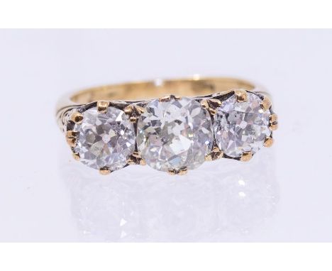 A diamond and 18ct gold three stone ring, comprising three old European cut diamonds, the principal stone weighing approx 1.5