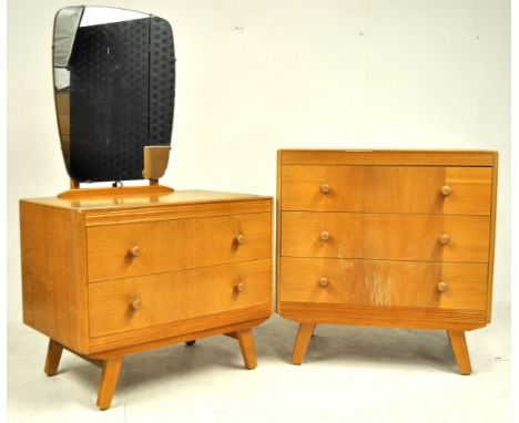 A retro vintage mid 20th century light oak bedroom suite comprising of an upright chest of drawers having a bank of three dra