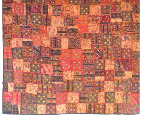 A large vintage 20th century Indian patchwork blanket / rug having repeating geometric motifs with mirrored panels.