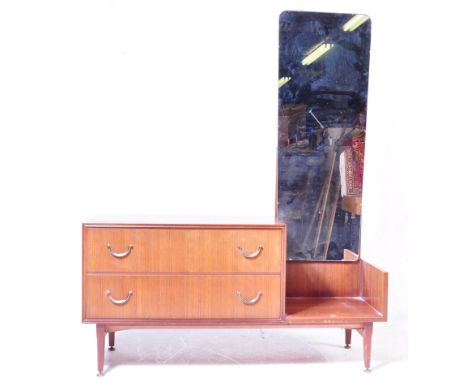 A mid century teak wood dressing table by Meredew. Raised on tapering legs with a low and wide body comprising a series of dr