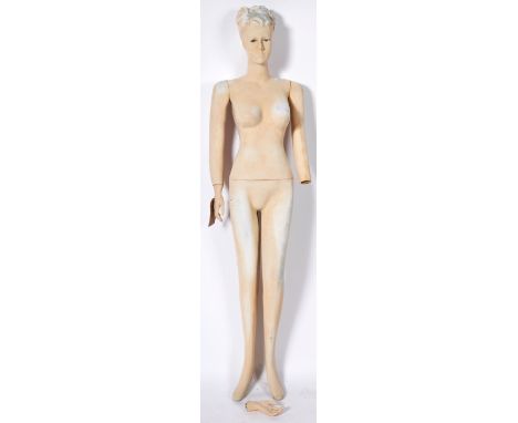 A vintage mid 20th Century full body female shop display mannequin having articulated arms and legs with hair done typical of
