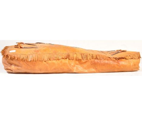 A vintage 20th Century Native American leather footstool of rectangular form having stitched geometric decoration with tassel