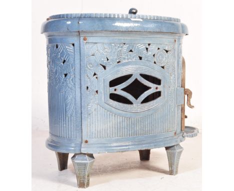 
An early 20th century French enamel wood burner stove. Light blue enamel colourway to the lozenge shaped body with lattice w
