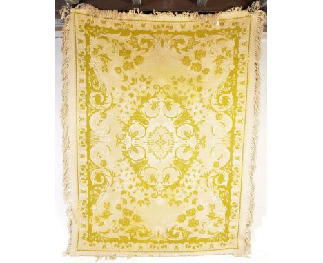 A large green and beige Damask Jacquard loom floor rug. The green and beige colourful rug with repeating scroll and leaf geom