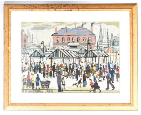 NE Anthony 1989 -&nbsp; Manner of L. S. Lowry - Market Scene, Northern Town - A framed and glazed machine woven needlepoint t
