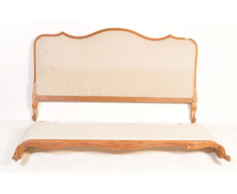 A vintage 20th century French walnut corbeille single bed having a serpentine carved headboard and footboard upholstered in c