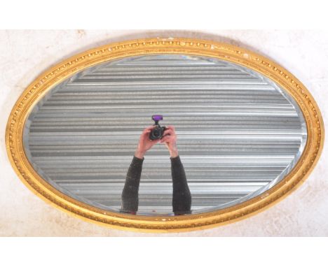 A 19th century Victorian giltwood and gesso worked oval over mantel mirror. Oval frame with gilt gesso wooden frame having in