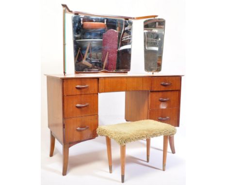 A mid century teak wood dressing table and stool by Wrighton Furniture. Raised on tapering legs with banks of drawers either 