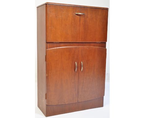 A mid century, circa 1950's post war Art Deco cocktail drinks cabinet. The walnut&nbsp; cabinet with inset plinth base having