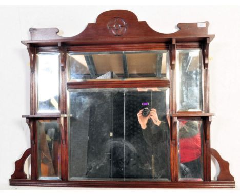 A 19th century Victorian mahogany over mantel mirror having a carved flower to the to the top, six mirrored panel flanked by 