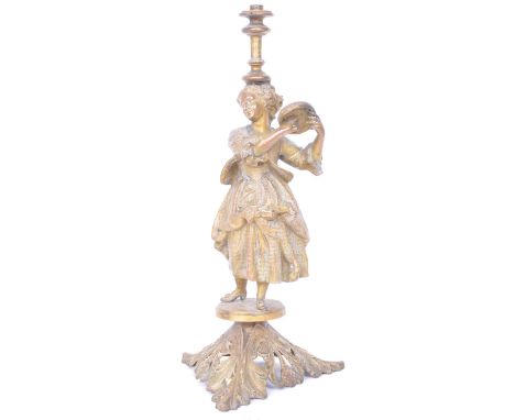 A 19th century French ormolu and brass table lamp in the form of a woman playing a tambourine raised on a pierced acanthus le