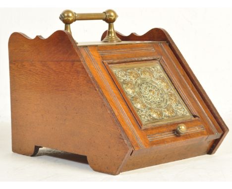 A 19th century Victorian mahogany and brass coal scuttle purdonium. The mahogany base with inset brass panel to the hinged to