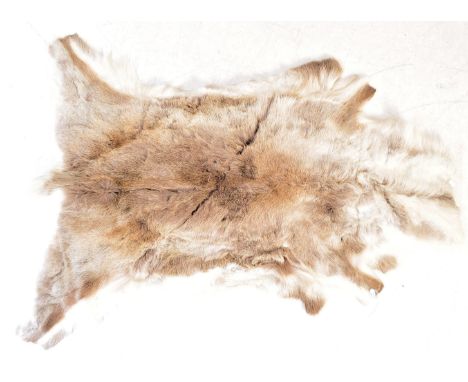 A mid 20th century retro vintage deer skin fur rug carpet with white suede underlay.