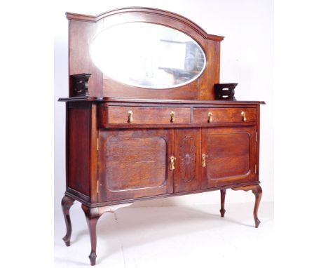 An early 20th century circa 1920s oak Jacobean revival sideboard having a chamfered edge over a run of two drawers with brass