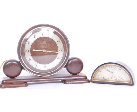 A 1930'sd Art Deco demi-lune / half moon small mantel clock with silvered dial , brass fitting and feet. Possibly Bakelite ca