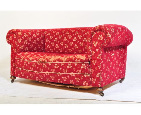 A Victorian 19th century Chesterfield drop arm sofa settee. Raised on squat bun feet having a moquette upholstered wide and d