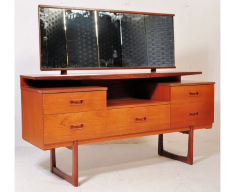 A retro vintage mid 20th century dressing table having a wide mirror atop a floating shelf with a run of drawers below raised