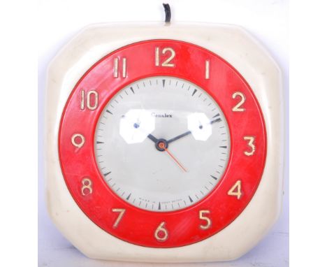 A retro vintage mid 20th century Genalex cream and red Bakelite clock having Arabic numerals to the chapter ring. Makers badg