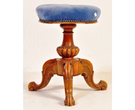 A Victorian 19th century mahogany revolving piano stool. The stool being raised on a reeded tapering column with trefoil base