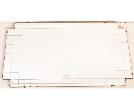 A 1930's Art Deco frameless over mantel mirror. The unusual shaped rectangular mirror with geometric etched design to the edg