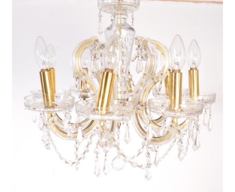 A vintage 20th Century glass chandelier ceiling light having a central column with 8 scrolled glass arm branch sconces with a
