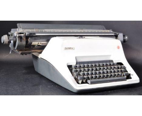 A retro vintage mid 20th Century 1960's Olympia office typewriter. Black and white plastic case with series of typing keys. A