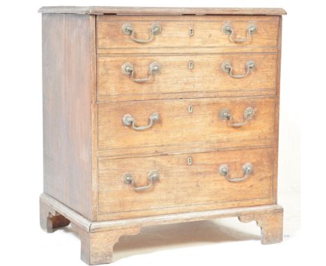 A 19th century George III oak bachelors chest commode. Raised on bracket feet with a faux drawer front having brass swing han