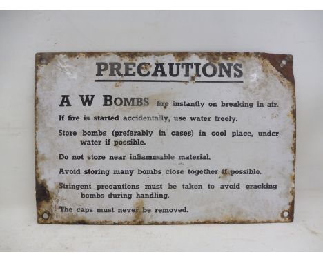 A rectangular enamel sign - 'Precautions A.W. Bombs Fire Instantly On Breaking In Air...' 12 x 8".