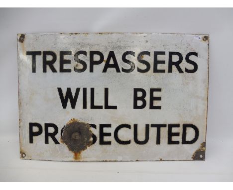 A 'Trespassers...' recatngular enamel sign.