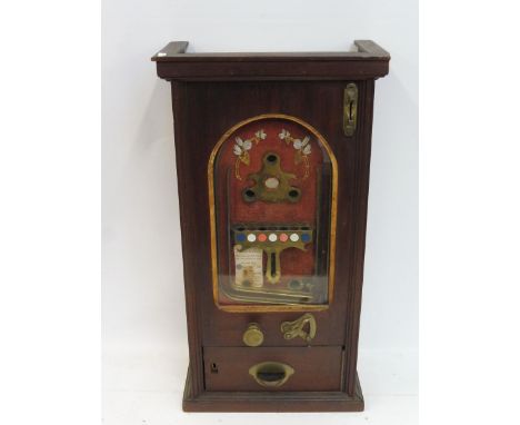 A rare and early slot machine, circa 1910 of small size, by repute only one known in this size, and can be played effectively