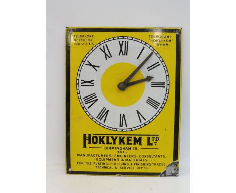 A Hoklykem Ltd enamel fronted clock, 9 1/2 x 12 1/4".