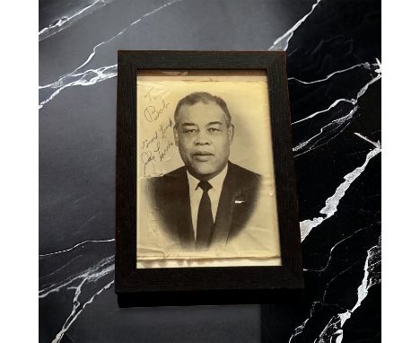 Joe Louis signed 14x10 inch approx framed vintage black and white photo dedicated. Good condition. All autographs come with a