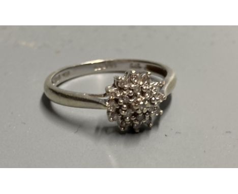 A modern 9ct white gold and diamond cluster ring, size M/N, gross 2 grams.CONDITION: Some wear to the rhodium plating. Minor 