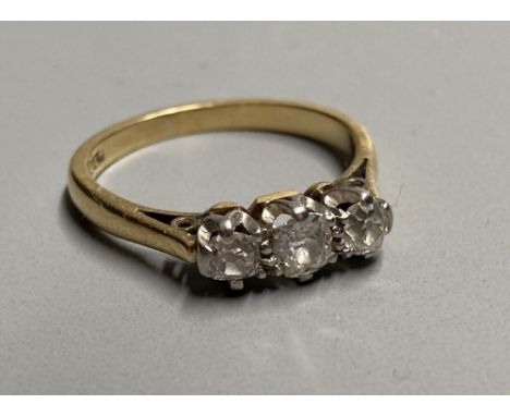 A mid 20th century 18ct and three stone diamond ring, size K/L, gross 2.7 grams.CONDITION: Some minor wear to the settings an