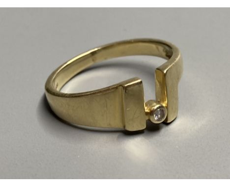 A modernist continental 585 yellow metal and single stone diamond ring, size O/P, gross 4 grams.CONDITION: Minor scratches to