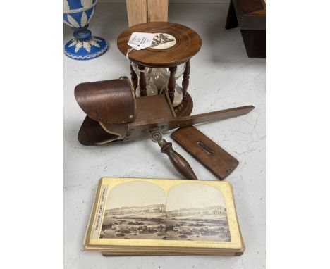 A stereoscope viewer with slides and a sand timer