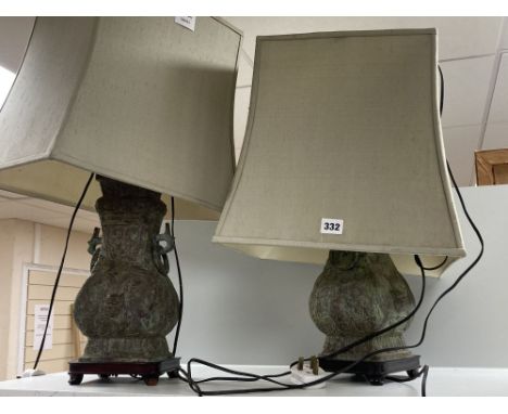 A pair of Chinese bronze lamp bases, in Zhou dynasty style, 36cm high excluding light fittings