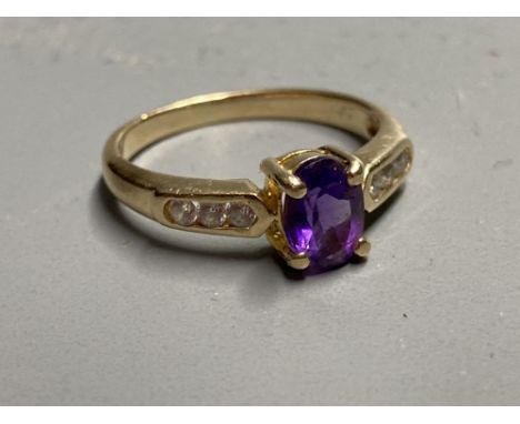 A modern yellow metal, amethyst ring with white stone (possibly white sapphire) set shoulders, size L, gross 2.7 grams.CONDIT