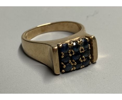 A mid to late 20th century 9ct and nine stone sapphire square cluster ring, size L, gross 5.6 grams.CONDITION: One of the sap