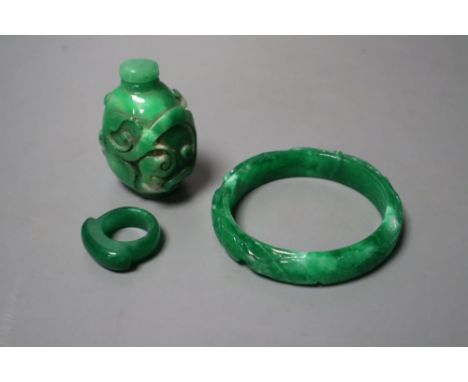 A Chinese green jadeite snuff bottle and stopper, a similar 'phoenix &amp; dragon' bangle and an archer's ring