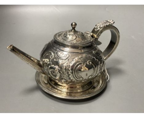 A George III Irish embossed silver bachelor's teapot, James Scott, Dublin, 1804, on an associated Irish silver circular stand