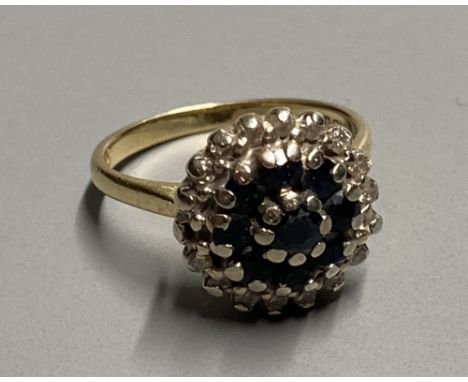 A modern 18ct gold, sapphire and diamond cluster dress ring, size K, gross 5.2 grams.CONDITION: Small diamond missing. Highes